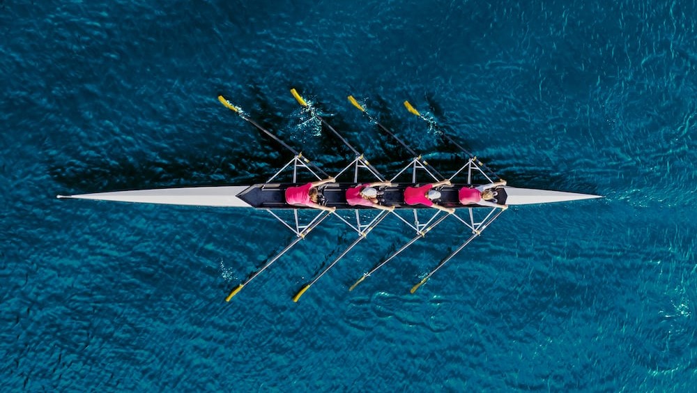 Team of rowers working together to win a race